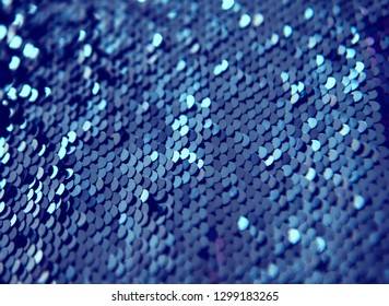 Shining and bright blue texture made from sequins. Fish scales effect