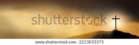 Shining cross on Calvary hill, sunrise, sunset sky background. Copy space. Ascension day concept. Christian Easter. Faith in Jesus Christ. Christianity. Church worship, salvation concept. Gate to