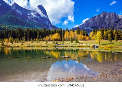 Shining Day In Canmore. The  Three Sisters Mountains In The Canadian Rockies. Concept Of Hiking