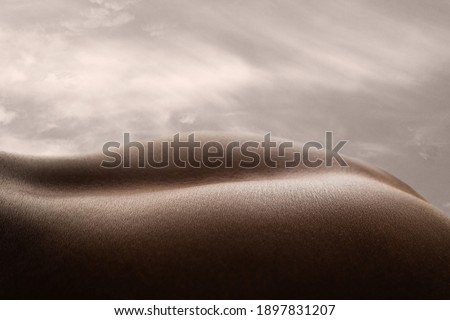 Shining. Detailed texture of human skin. Close up of young african-american male body surface like landscape with the sky on background. Skincare, bodycare, healthcare, inspiration, fantasy artwork.