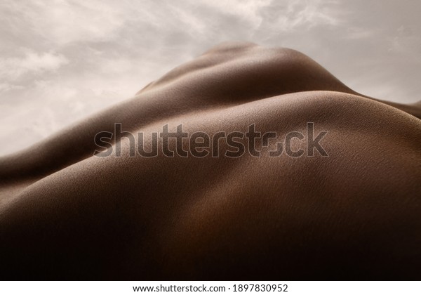 Shining. Detailed texture of human skin. Close\
up of young african-american male body surface like landscape with\
the sky on background. Skincare, bodycare, healthcare, inspiration,\
fantasy artwork.