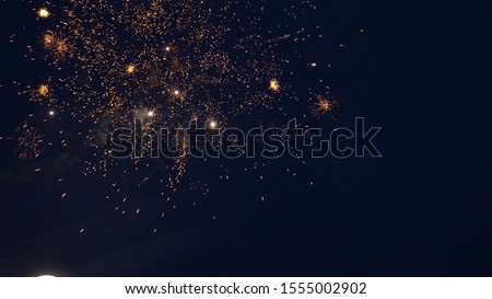 shining fireworks with bokeh lights in night sky. glowing fireworks show. New year's eve fireworks celebration. multico lored fireworks in night sky. beautiful colored night explosions in black sky