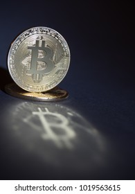shining golden bitcoin on a dark background