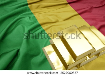 shining golden bullions on the mali flag background. gold reserves. macro shot