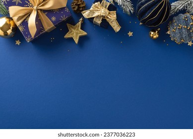 Shining Holiday Magic: Overhead photo of twinkling wrapped gifts, ornaments, evergreen twigs with frost accents on luxurious blue background, with unoccupied spot for your festive greeting or advert - Powered by Shutterstock