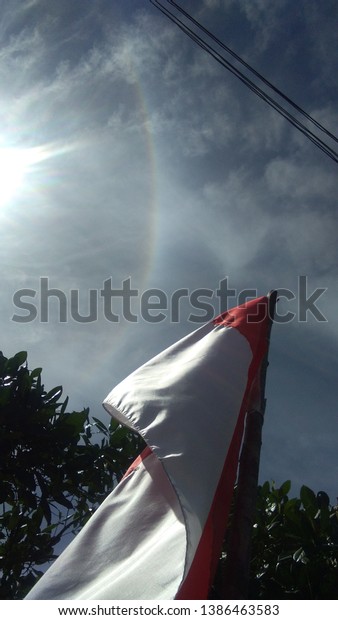 Shining Indonesia\
flag under sky. Hello\
sun