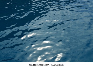 Shining On The Sun Tranquil Dark Blue Sea Water Surface Seen From Above