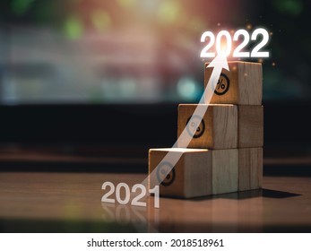 Shining Rise Up Arrow On Wooden Blocks Chart Steps With Percentage Icons From Year 2021 To 2022 On Wooden Desk, Business Growth Process, And Economic Improvement Concept.