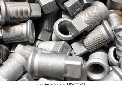 Shining Wheel Mounting Nuts Car, Tractor, Truck, Heavy Machinery Close Up. Industrial Background.