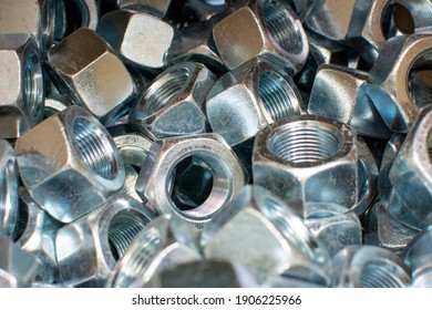 Shining Wheel Mounting Nuts Car, Tractor, Truck, Heavy Machinery Close Up. Industrial Background.