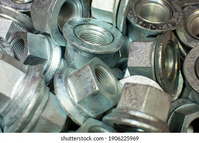 Shining Wheel Mounting Nuts Car, Tractor, Truck, Heavy Machinery Close Up. Industrial Background.