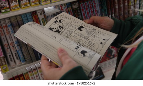 Shinjuku, Tokyo,Japan - March, 4th, 2021: A Person Reading Manga Magazines In A Book Store.