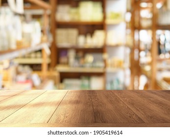 Shinny Empty Natural Wooden Counter Top In An Eco-friendly Grocery Store With Beautiful Wooden Products Shelf In Background. Nobody, Healthy Products Display, Day Light, Blurred, Selective Focus.