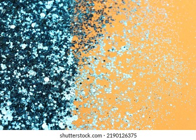 Shiny Bright Light Blue Glitter On Pale Orange Background