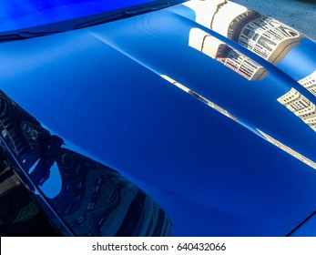 Shiny Car Hood With Building's Reflection 