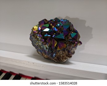 Shiny Crystal Titanium Ore On White Piano Background