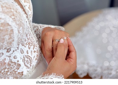 Shiny engagement ring on the bride's hand and empty space for text - Shutterstock ID 2217909513