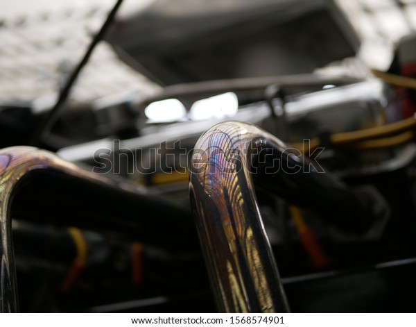 shiny exhaust pipe of the car changed color\
due to the high exhaust gas\
temperature.