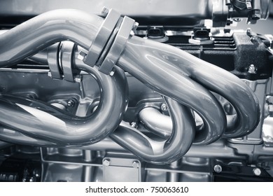Shiny exhaust pipes. Motor parts, automotive V12 engine fragment, closeup photo with selective focus