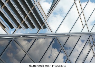 Shiny Glass Wall With Darkening Glass And Sheer Glass Joint With Sky Reflection, Mirrorlike