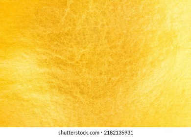 Shiny gold background made of rough textured gold leaf. - Shutterstock ID 2182135931