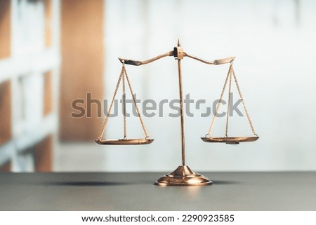 Shiny golden balanced scale in court library background as concept justice and fairness legal symbol. Scale balance for righteous and equality judgment by lawyer and attorney. equility