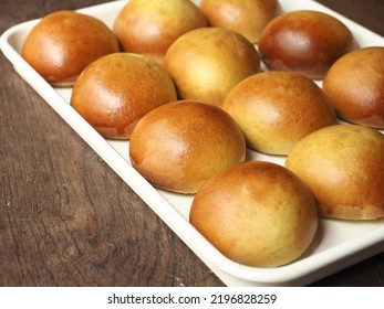 Shiny Golden Brown Baked Dinner Bread Rolls In White Baking Tray On Wood