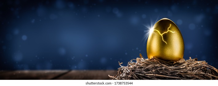 Shiny Golden Nest Egg On Wooden Table Cracking Open With Burst Of Light - Investment Maturity Concept - Powered by Shutterstock