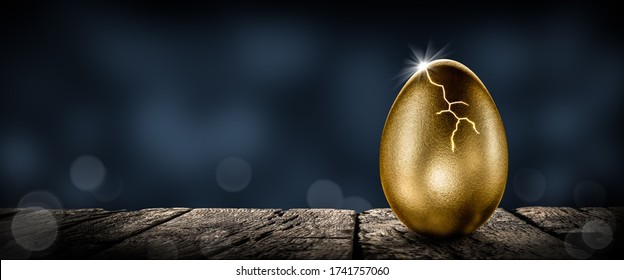 Shiny Golden Nest Egg On Wooden Table Cracking Open With Burst Of Light - Investment Maturity Concept - Powered by Shutterstock