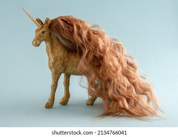 Shiny Golden Unicorn With Long Curly Hair On Pastel Blue Background. Minimal Art Fantasy Poster.