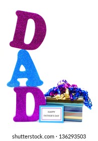 Shiny Letters Spelling DAD With Gift Box And Happy Fathers Day Tag