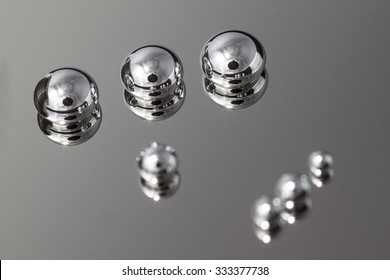 Shiny Mercury Drops On A Metal Background