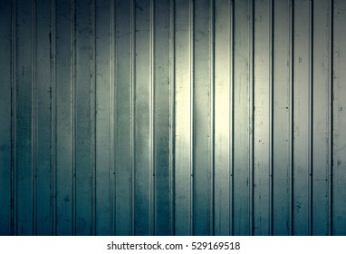 Shiny metal fence, detail of a wall of dirty and rusty metal, shiny metal background