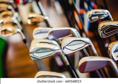 A shiny metal golf clubs for sale show in shop rack.