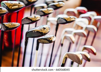 A Shiny Metal Golf Clubs For Sale Show In Shop Rack.