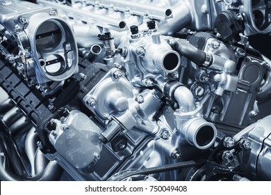Shiny motor details, V12 car engine fragment, closeup photo with selective focus