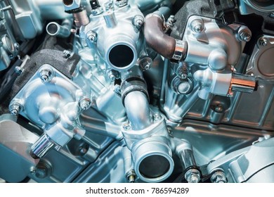 Shiny motor details, V12 car engine fragment, closeup blue toned photo with selective focus
