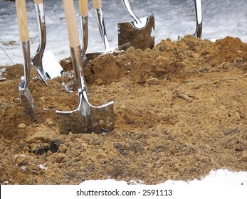 Shiny New Shovels In Sand For Ground Breaking Ceremony