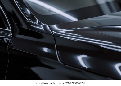 shiny paint on black cars. Glossy paint on a black car.
