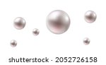shiny pearls of different sizes on a white background