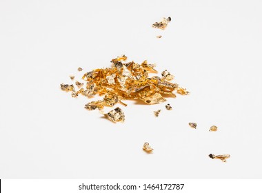 Shiny Pieces Of Gold Leaf On A White Background 