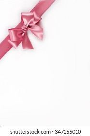 Shiny pink ribbon bow isolated on white
