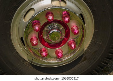 Shiny Red Bolt In Truck Wheel