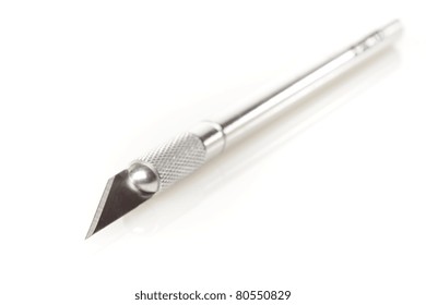 A shiny silver cutting utensil against a white background