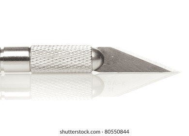 A shiny silver cutting utensil against a white background