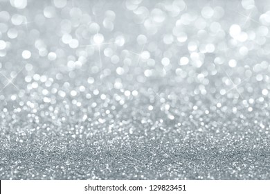 Shiny silver defocused glitter background with copy space