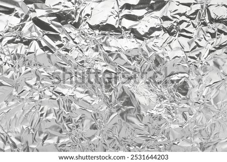 Shiny silver tinfoil surface as background, top view
