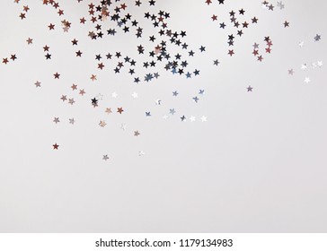 Shiny Star Shaped Confetti Of Silver Color On The White Background