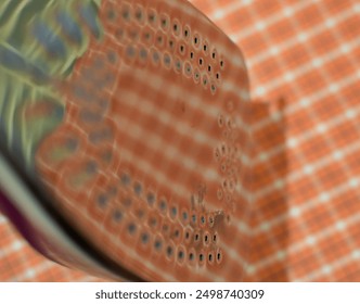 Shiny steam iron base plate with reflection of a red checked man's shirt ready to be ironed. Domestic chores. Semi abstract.  Close up, copy space. - Powered by Shutterstock