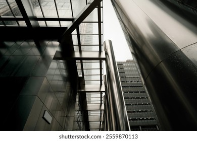 Shiny steel pillars and a glass roof create a modern and impressive architectural scene in canary wharf, london, with a glimpse of a skyscraper in the background - Powered by Shutterstock